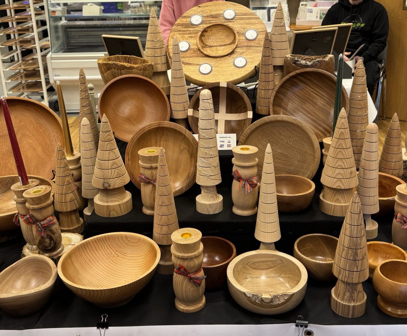 Crafty Fair Table Layout Various handcrafted wooden bowls and decorative items displayed in a market setting.